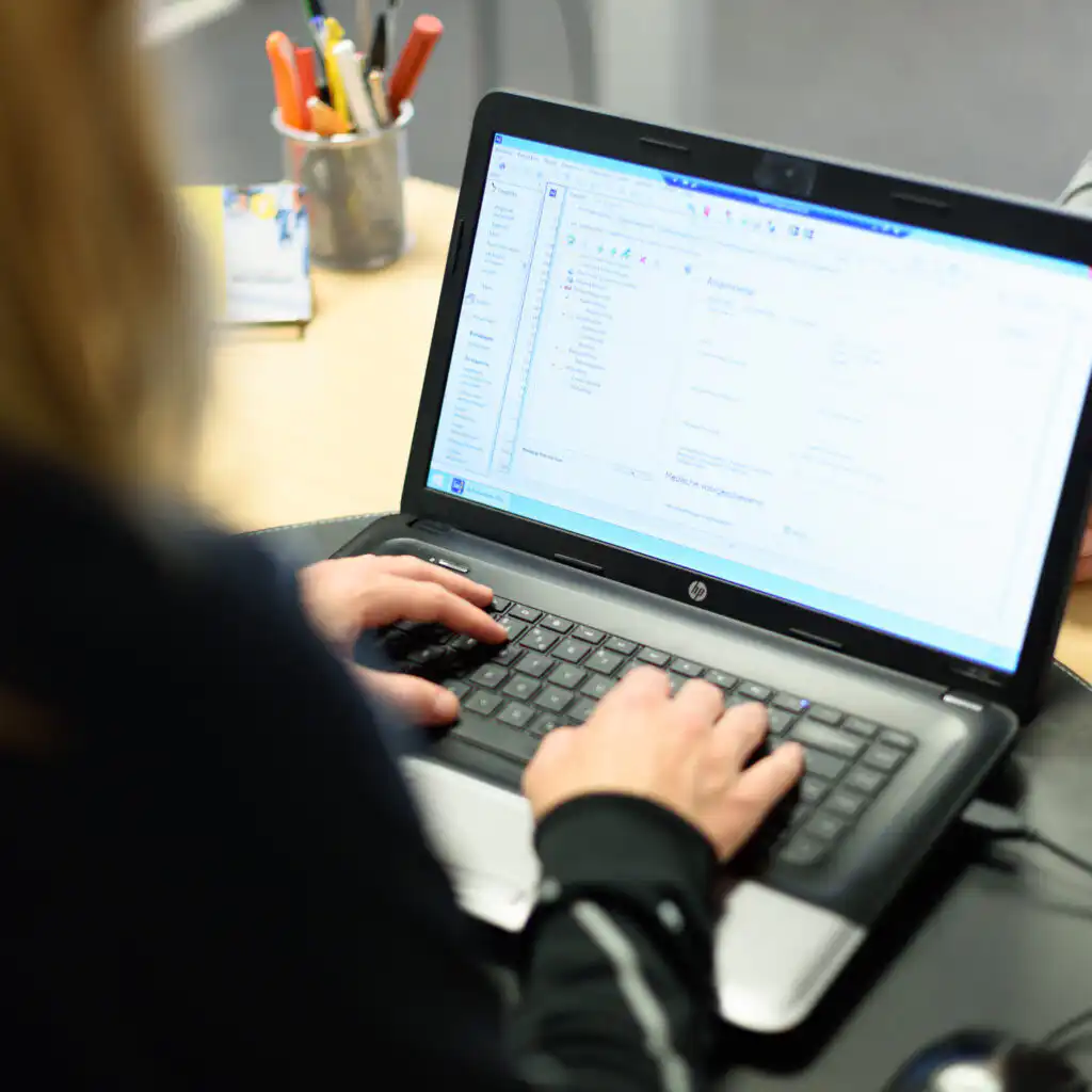 Een fysiotherapeut die Intramed gebruikt op haar laptop